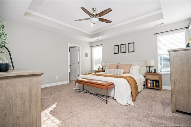 bedroom with carpet, visible vents, a raised ceiling, and baseboards