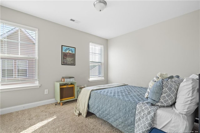 carpeted bedroom featuring visible vents and baseboards