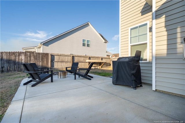 view of patio featuring a grill and fence