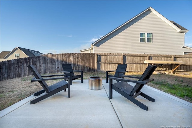 view of patio with an outdoor fire pit and a fenced backyard