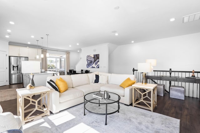 living area with dark wood-style floors, recessed lighting, and visible vents