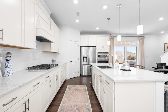 kitchen featuring tasteful backsplash, visible vents, appliances with stainless steel finishes, white cabinetry, and a sink