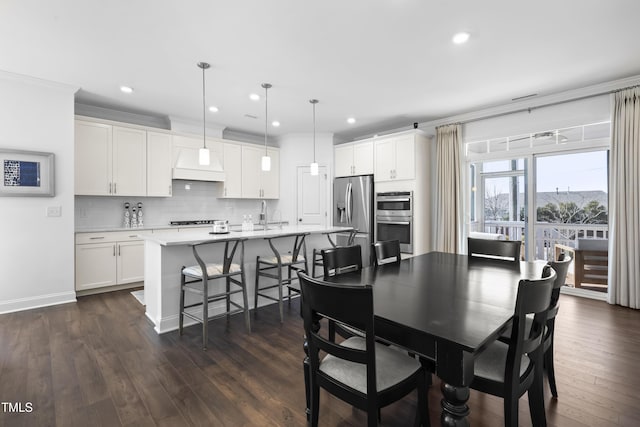 dining area with crown molding, baseboards, dark wood-style flooring, and recessed lighting