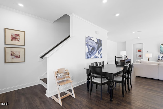 dining space featuring crown molding, stairs, baseboards, and wood finished floors