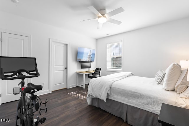 bedroom with ceiling fan, baseboards, and wood finished floors