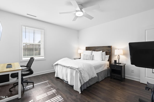 bedroom featuring ceiling fan, dark wood-style flooring, visible vents, and baseboards