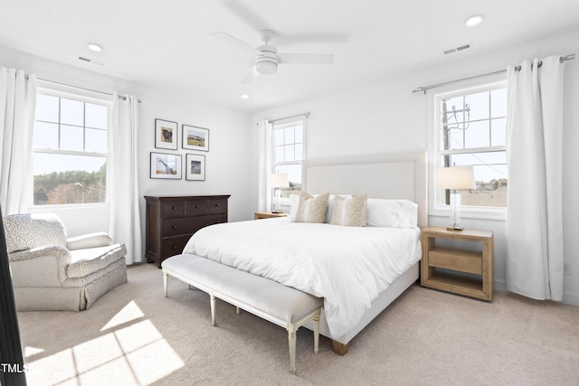 bedroom with light carpet, multiple windows, visible vents, and recessed lighting