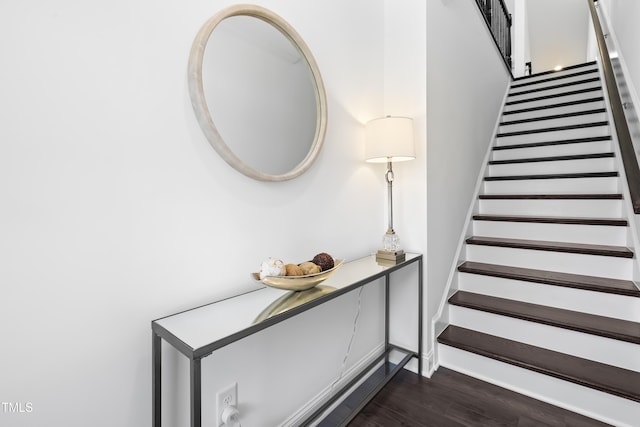 stairway featuring baseboards and wood finished floors