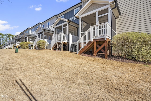 view of property exterior with a sunroom and stairway