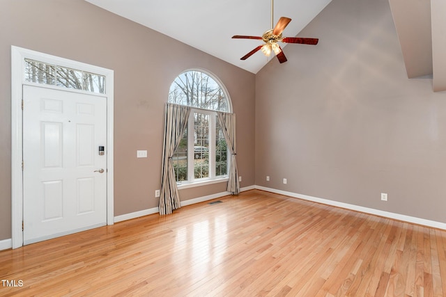 foyer featuring visible vents, a ceiling fan, high vaulted ceiling, light wood-type flooring, and baseboards