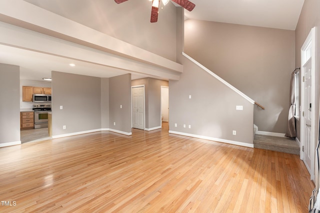 unfurnished living room featuring light wood-type flooring, stairway, and baseboards