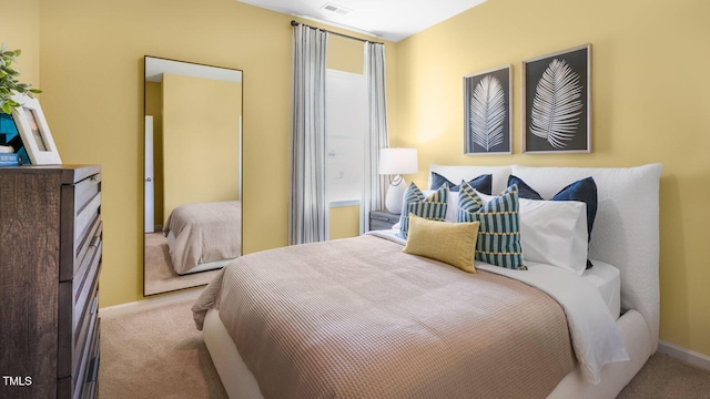 bedroom featuring carpet floors, visible vents, and baseboards