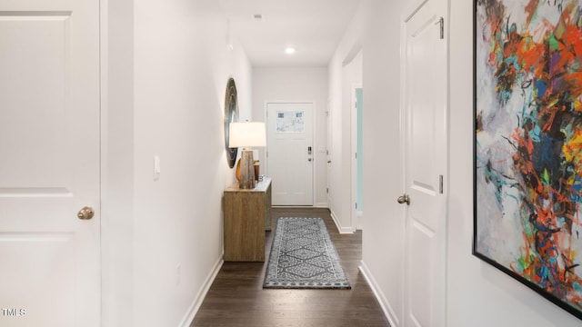 hall featuring dark wood-style floors, recessed lighting, and baseboards