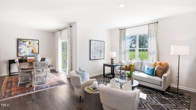 living area with baseboards and hardwood / wood-style floors