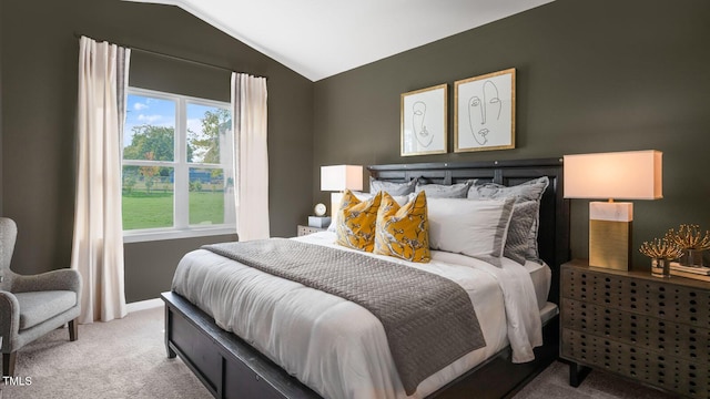 carpeted bedroom with lofted ceiling