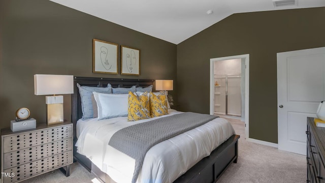 bedroom with baseboards, visible vents, light colored carpet, lofted ceiling, and ensuite bath