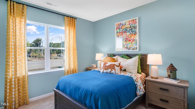 carpeted bedroom featuring visible vents and baseboards