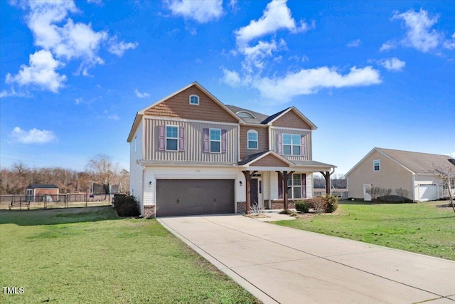 craftsman-style home featuring board and batten siding, a front yard, fence, a garage, and driveway