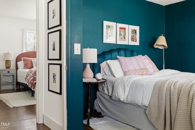 bedroom featuring baseboards and wood finished floors