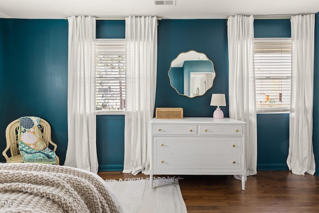 bedroom featuring dark wood finished floors and visible vents