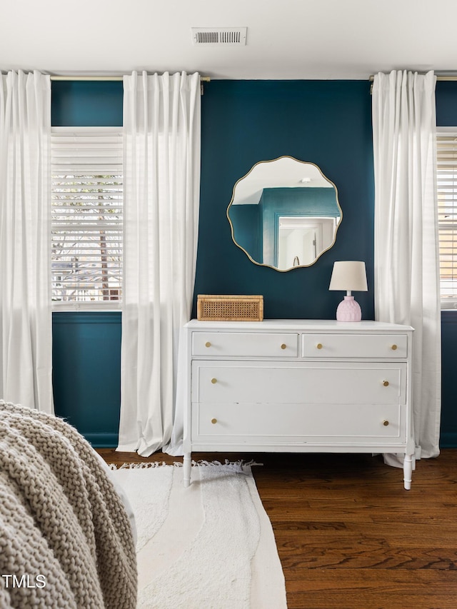 bedroom featuring visible vents and wood finished floors