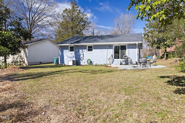 back of property featuring entry steps, central AC unit, a patio, a yard, and brick siding