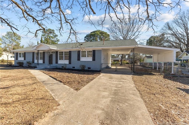 ranch-style house featuring crawl space, a gate, fence, a carport, and driveway