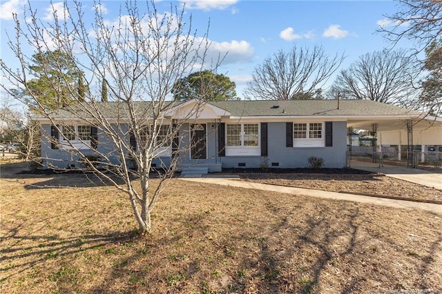 ranch-style house with concrete driveway, entry steps, crawl space, a carport, and a front lawn