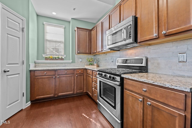 kitchen with stainless steel appliances and brown cabinetry