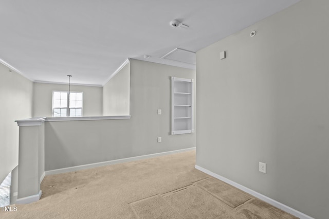 carpeted spare room with baseboards and ornamental molding