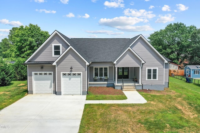 view of front of home with a garage, a front yard, covered porch, and roof with shingles