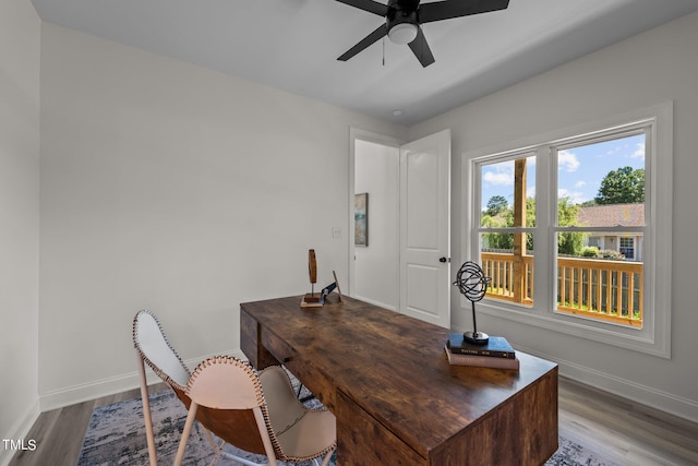 office featuring ceiling fan, baseboards, and wood finished floors