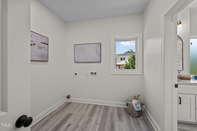 laundry area with laundry area, washer hookup, baseboards, light wood-type flooring, and electric dryer hookup