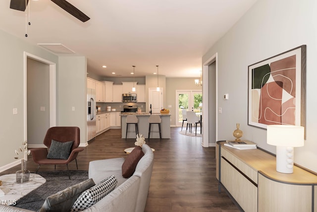 living room featuring recessed lighting, baseboards, ceiling fan, and dark wood finished floors