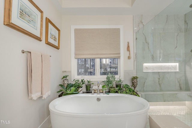 bathroom with a freestanding bath and a marble finish shower