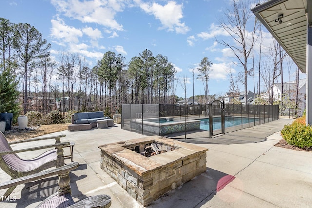 exterior space featuring fence, a fire pit, a fenced in pool, and a patio