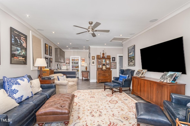 living room featuring recessed lighting, wood finished floors, a ceiling fan, attic access, and crown molding