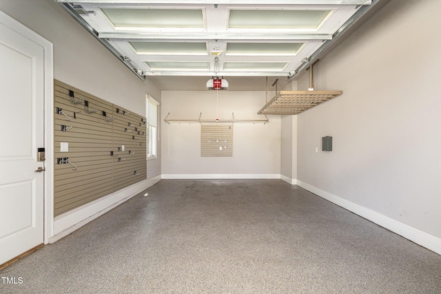 garage with a garage door opener and baseboards