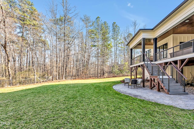 view of yard featuring a patio area and stairs