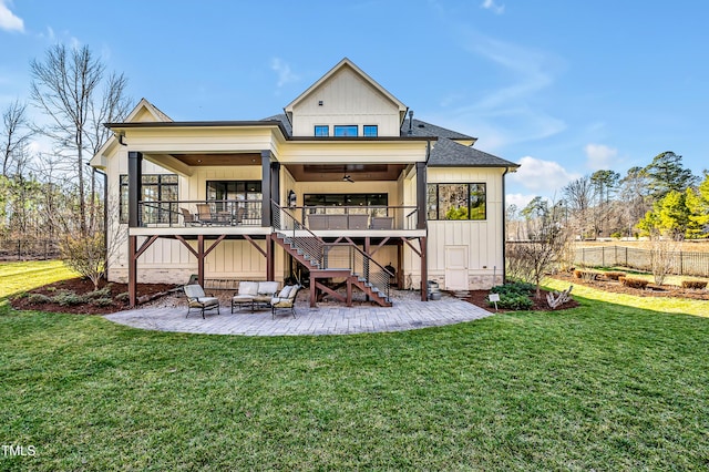 rear view of house featuring fence, stairway, a lawn, board and batten siding, and a patio area