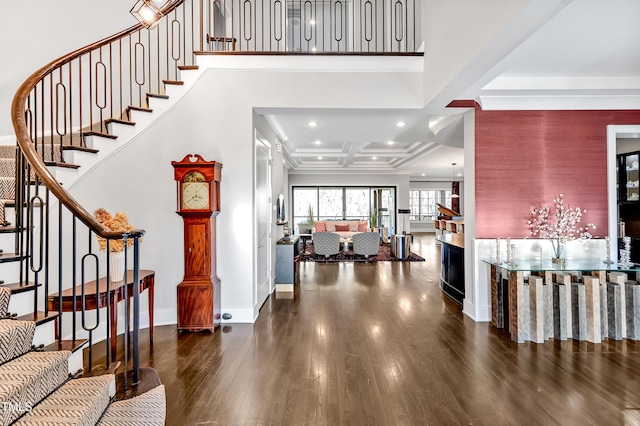 foyer entrance with baseboards, coffered ceiling, wood finished floors, stairs, and recessed lighting