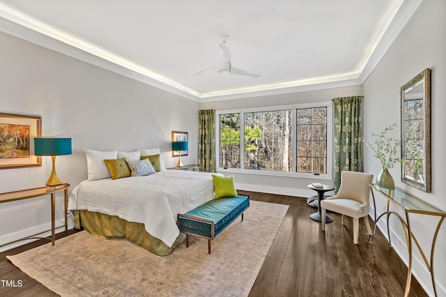 bedroom with wood finished floors and baseboards