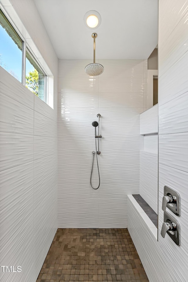 full bath with a tile shower