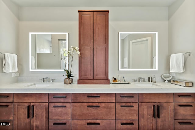 bathroom featuring a sink and double vanity