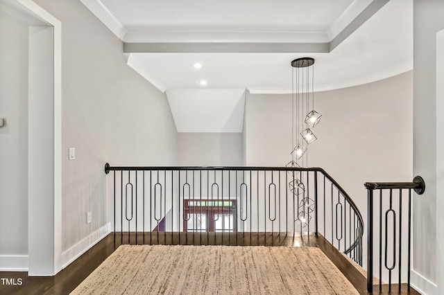 corridor with recessed lighting, wood finished floors, an upstairs landing, baseboards, and crown molding