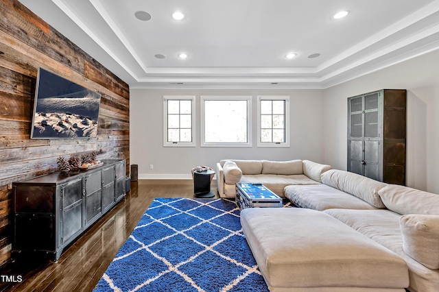 living room featuring recessed lighting, a raised ceiling, and wood finished floors