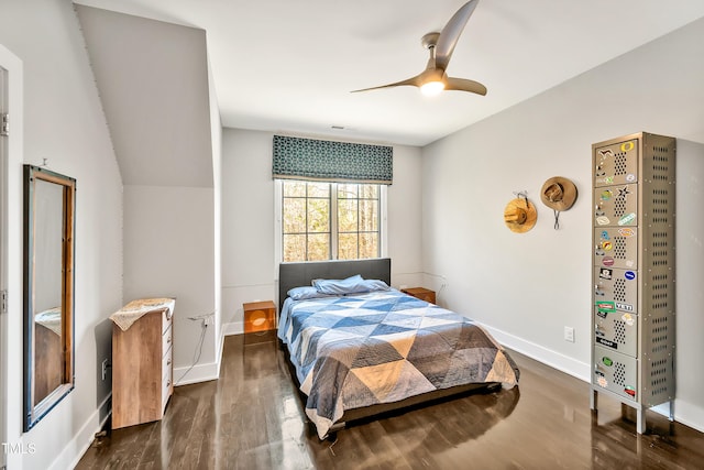 bedroom featuring ceiling fan, wood finished floors, lofted ceiling, and baseboards