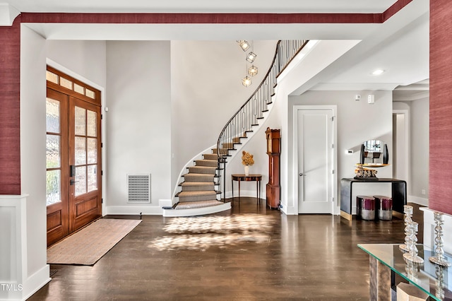 entryway featuring baseboards, visible vents, stairway, wood finished floors, and french doors