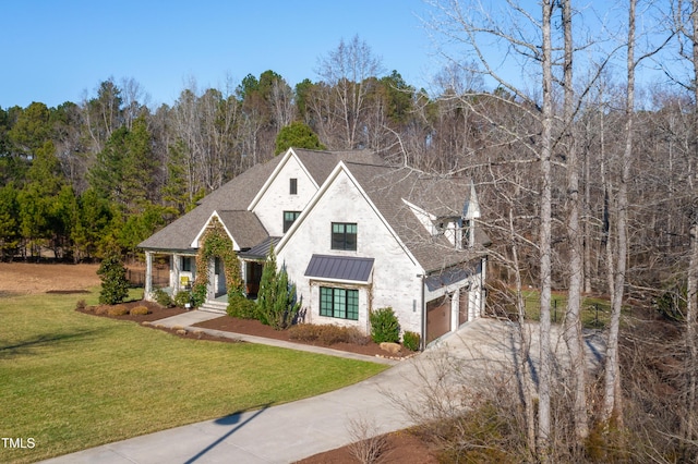 view of front of property featuring concrete driveway, metal roof, roof with shingles, a standing seam roof, and a front yard