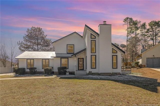 mid-century inspired home featuring a yard and a chimney